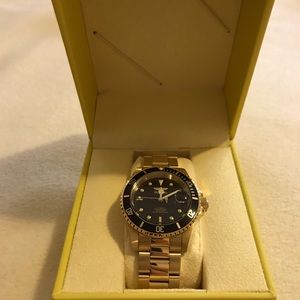 Invicta gold tone and black face watch.